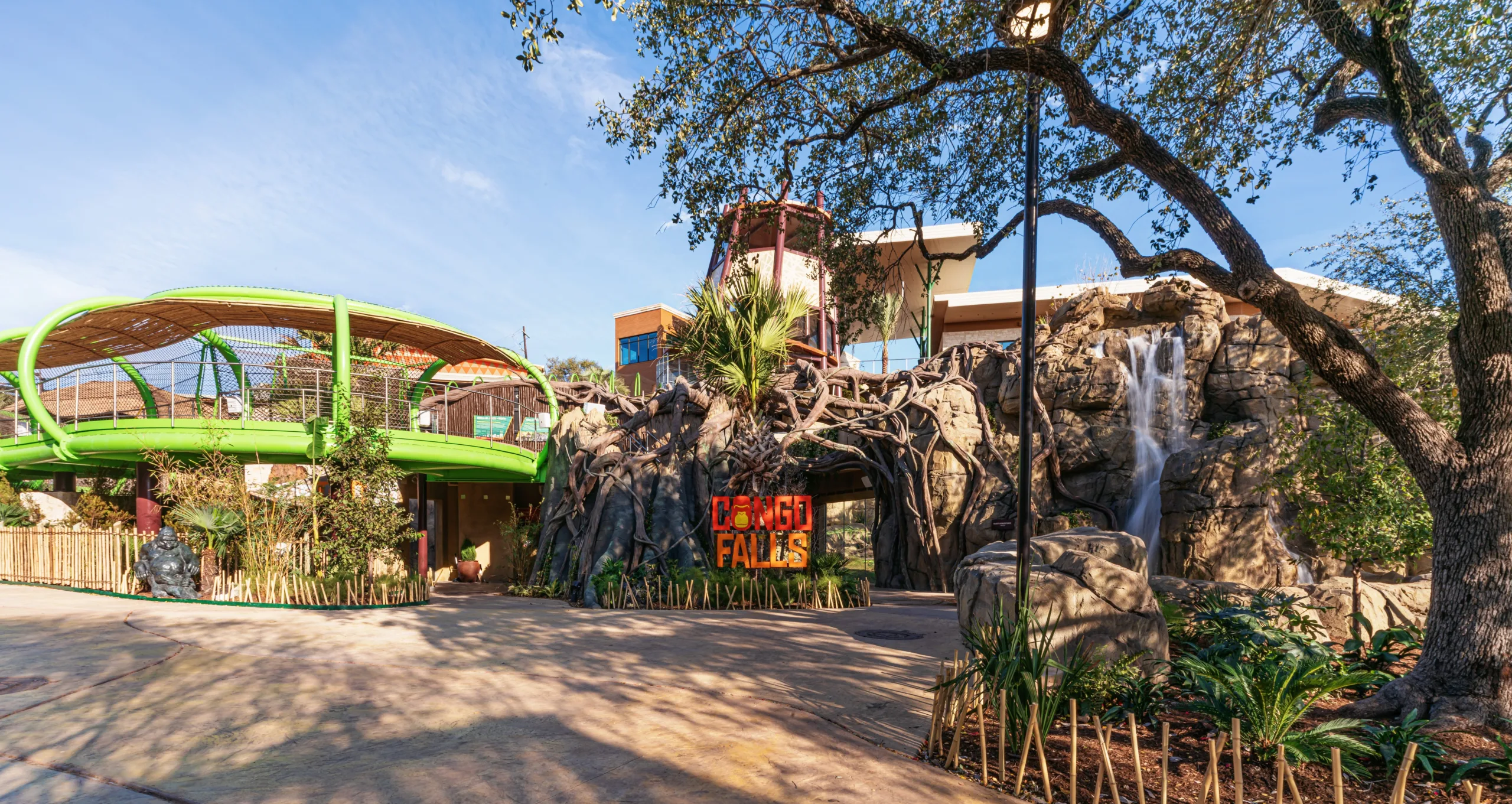 Entrance to Congo Falls at San Antonio Zoo, with rockwork, a waterfall and green elevated gorilla trails