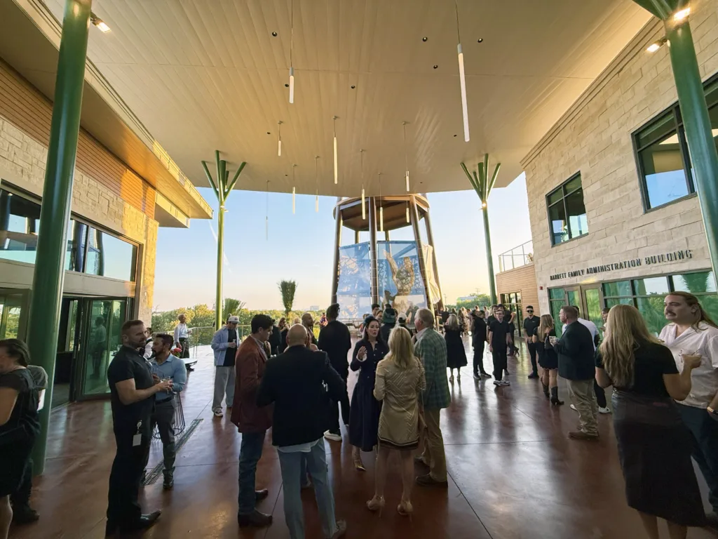 Guests mingling on the covered terrace of The Ralston event center overlooking Congo Falls