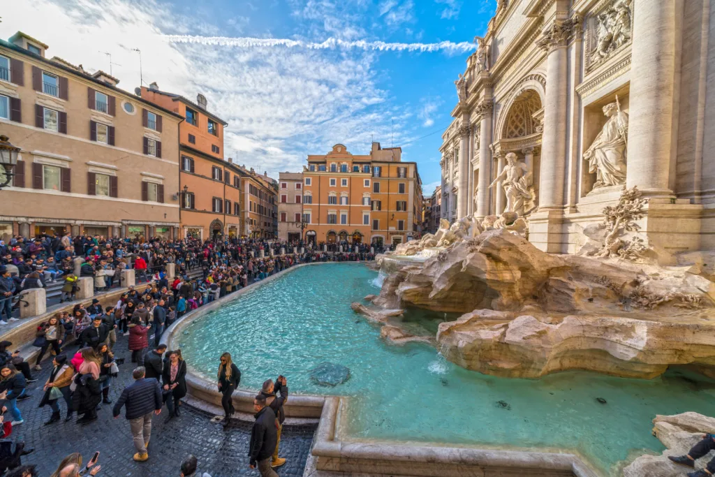 Crowds of tourists gathered around the Trevi Fountain in Rome