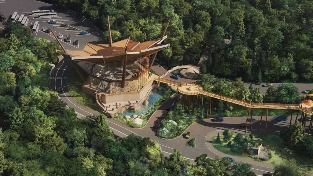 Aerial rendering of the Experience Center, with a peaked timber roof and elevated walkway in the forest