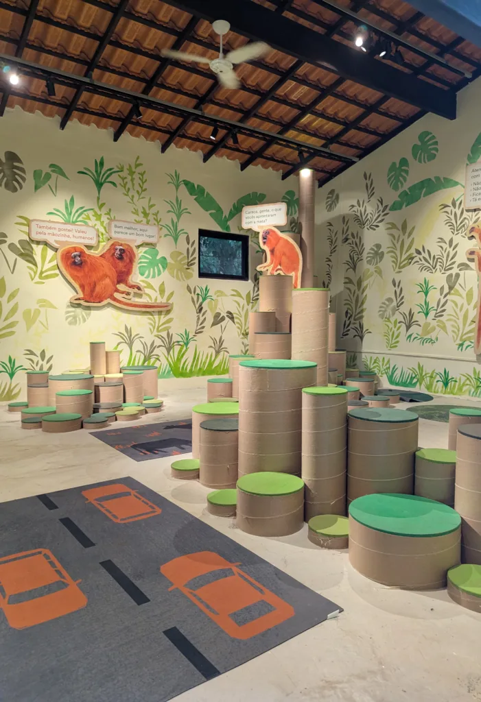 Children's exhibit with tamarin cutouts and stepping stumps at the Associação Mico-Leão-Dourado Learning Center