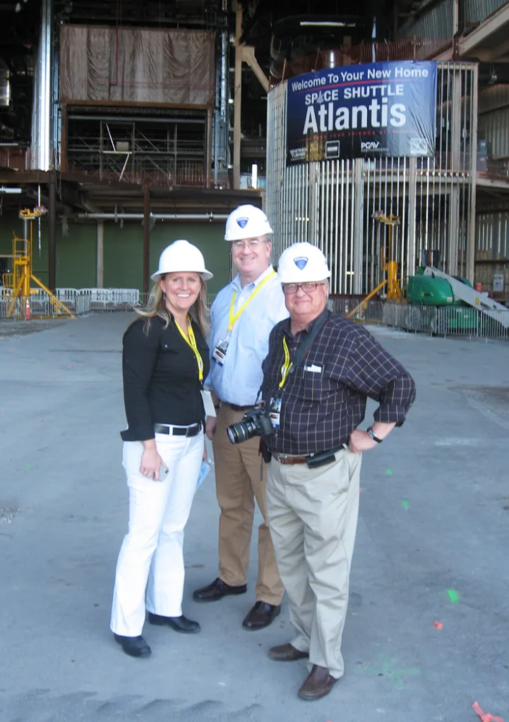 Mike Konzen and two PGAV colleagues in hard hats at the Space Shuttle Atlantis construction site, Kennedy Space Center