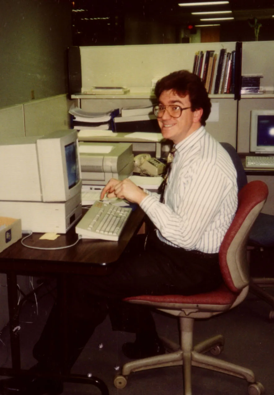 Mike Konzen early in his PGAV career, seated at a desk with a beige desktop computer